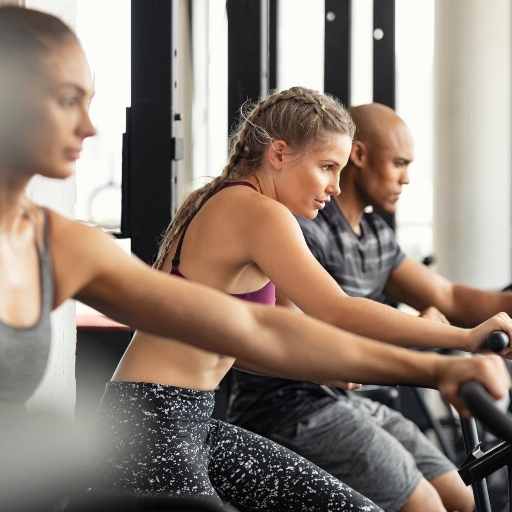 Focused Woman Exercising With Co-Workers